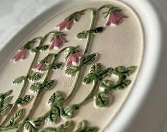 Gabriel Keramik Suecia. Colgante de pared de cerámica ovalada. Diseñado por Ingegärd. Parcialmente acristalado. Hermosas flores de Linnea. Década de 1970.