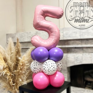 May include: A pink number 5 foil balloon sits on a tower of balloons. The tower includes purple, paw print, and pink balloons. The image also includes the text "mami and mimi est 2020" in a circular design.