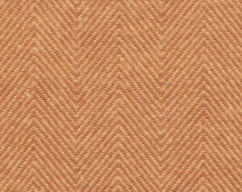 May include: A close-up of a fabric with a herringbone pattern in a light orange color.
