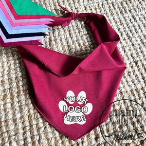 May include: Burgundy red bandana with a white paw print and the text "YOUR LOGO HERE" printed on it.
