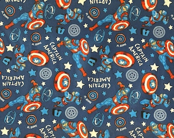 May include: Navy blue fabric featuring a repeating pattern of Captain America illustrations, shields, stars, and text. The text reads "CAPTAIN AMERICA" and "SINCE 41". The design includes red, white, and blue elements.