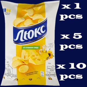 May include: A bag of potato chips with the brand name "Люкс" in blue and white. The bag features images of cheese, sunflower oil, and chips. Text on the bag reads "with cheese flavor" and "potato chips with cheese flavor."