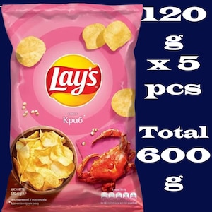 Puede incluir: Una bolsa rosa de patatas fritas Lay's con sabor a cangrejo. La bolsa tiene una imagen de un cangrejo. El texto en la bolsa dice "Lay's" y "Cangrejo". La bolsa es de 120 gramos y hay 5 bolsas en total, para un total de 600 gramos.