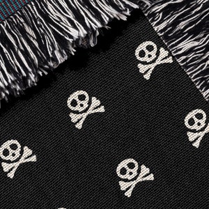 May include: Black throw blanket with a white skull and crossbones pattern. The blanket has a fringe border.