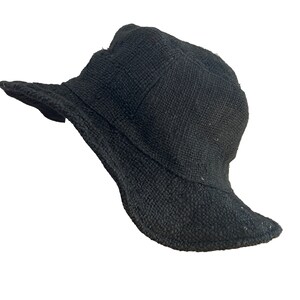 May include: A black woven bucket hat with a wide brim.