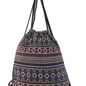 May include: A purple, black, yellow and white patterned drawstring bag with black drawstrings.