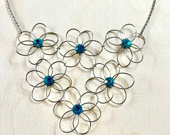 Flower bib necklace. Wire work flower necklace with blue glass rhinestones. Item comes gift boxed.