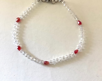 Beaded anklet with clear faceted 6mm glass beads and red teardrop spacer beads. Gift bag included