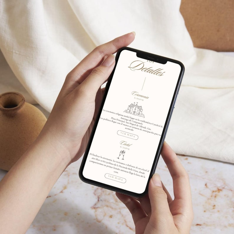 May include: A smartphone displays wedding details, held by a person. The screen shows elegant script and icons for ceremony and reception information. The background is a soft, neutral tone.