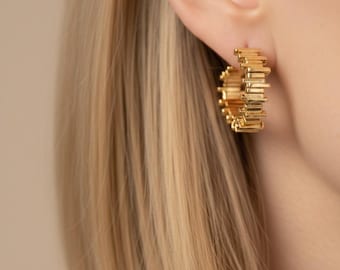 Sculptured Hoop. Coil earring formed from tightly wrapped rectangular links that spiral into a compact hoop shape.