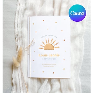Op de afbeelding: Een witte kaart met een gouden zon-afbeelding en de tekst "Heilige Taufe von Louis Jannis 10. September 2023 St. Sebastian Kirche Sandmännchen".