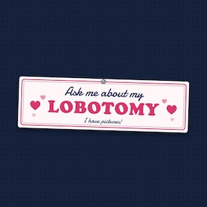 Ask me about my lobotomy bumper sticker: pink block letters and hearts on pale pink, with I have pictures in script underneath