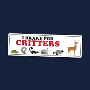 May include: A rectangular white sign with black and red text that reads I BRAKE FOR CRITTERS. The sign features colorful illustrations of a turtle, squirrel, skunk, opossum, raccoon, and deer lined up along the bottom edge.