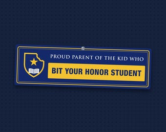 May include: A rectangular navy blue sign with a yellow border and a yellow shield icon featuring a star and an open book. The text reads: PROUD PARENT OF THE KID WHO BIT YOUR HONOR STUDENT, with the second line in a yellow rectangular box.
