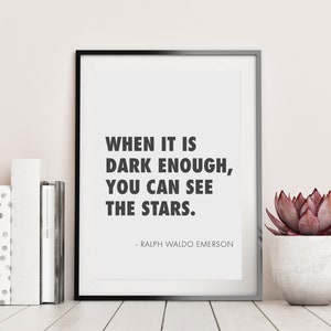 Puede incluir: Impresión enmarcada en blanco y negro con una cita de Ralph Waldo Emerson: "Cuando está lo suficientemente oscuro, puedes ver las estrellas."