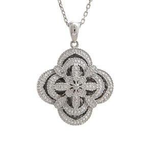 May include: A silver-toned pendant necklace featuring a four-leaf clover design. The pendant is encrusted with small, sparkling stones, creating a dazzling effect. The necklace has a delicate chain.