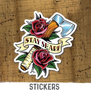 May include: A sticker featuring a stylized illustration of an axe with a wooden handle and a blue blade, wrapped in a banner with the text "STAY SHARP". The axe is surrounded by two red roses with green leaves.
