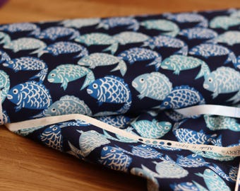 Cotton fabric with fish print in blue, suitable for clothing or accessories