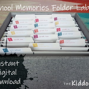 May include: A set of 12 white file folder labels with colourful numbers and text. The labels are for organising school memories by grade level, from pre-school to grade 12. The labels are in a grey file box with the text "THE Kiddo FILE" on the bottom.