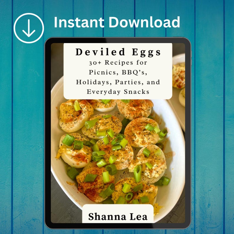 May include: A digital tablet displays a recipe book titled "Deviled Eggs" with the text "30+ Recipes for Picnics, BBQ's, Holidays, Parties, and Everyday Snacks." The image shows deviled eggs garnished with green onions. The author's name, Shanna Lea, is also visible.