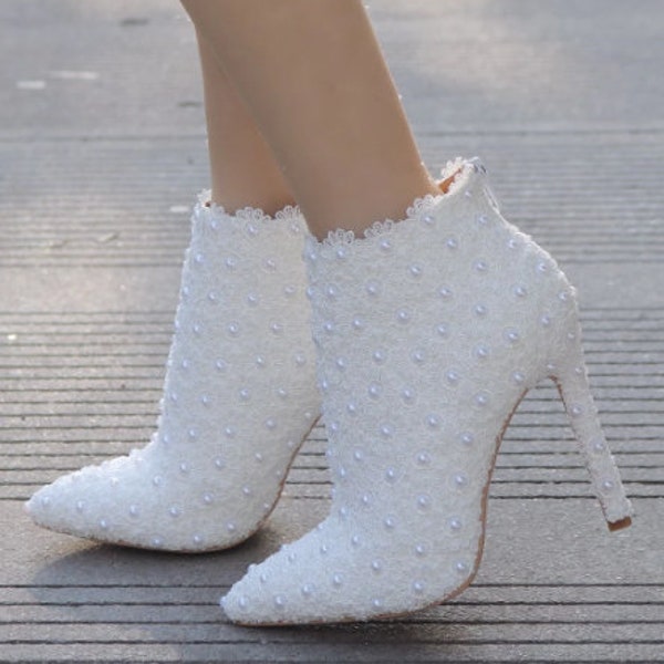 White pointed toe stiletto wedding ankle boots with back zipper, pearl booties, flower motif bridal boots