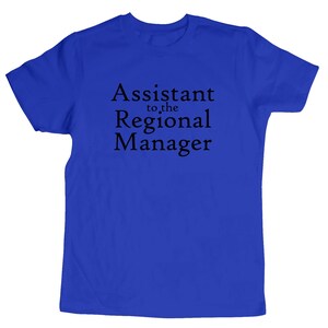 May include: A royal blue t-shirt with the text "Assistant to the Regional Manager" printed in black.