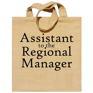 May include: A beige tote bag with black text that reads "Assistant to the Regional Manager".