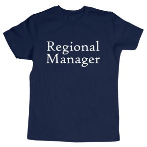 May include: A navy blue t-shirt with the text "Regional Manager" printed in white.