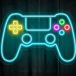 Puede incluir: Ilustración de neón de un mando de videojuegos. El mando está delineado en verde azulado brillante con botones amarillos, verdes, morados y rojos. El fondo es una veta de madera oscura.