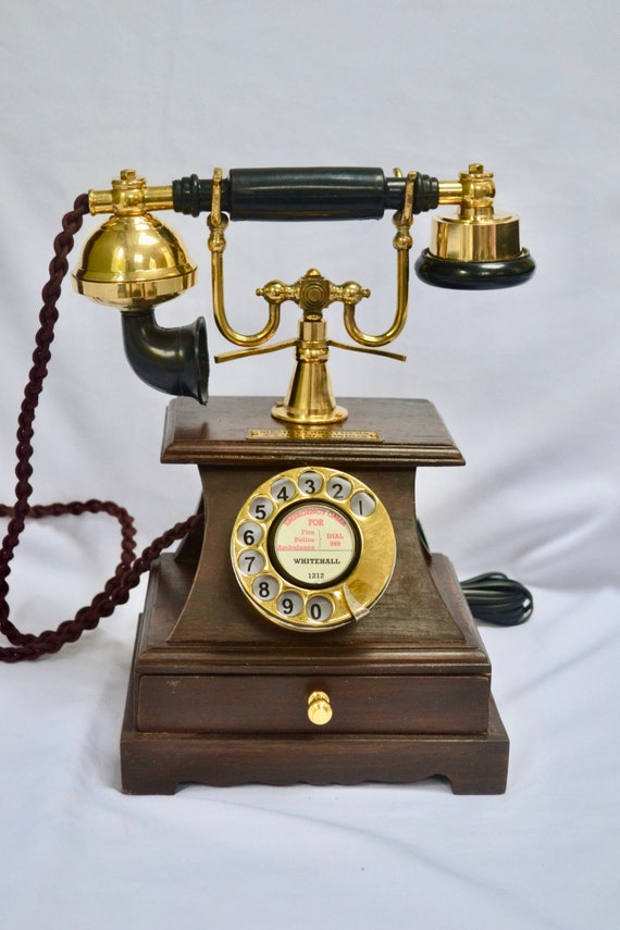 Old phone, Vintage telephone with wooden body and a gold tube.
