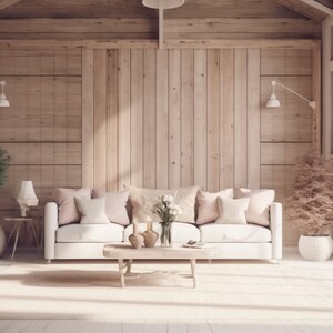 May include: A white sofa with pink and white pillows sits in a living room with a wooden wall and large windows. The room is decorated with plants and a coffee table with a vase of white flowers.