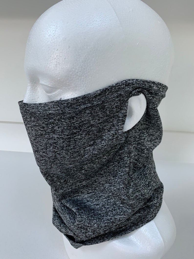 May include: Gray and black neck gaiter with a hole for the ear. The gaiter is made of a soft, stretchy material.