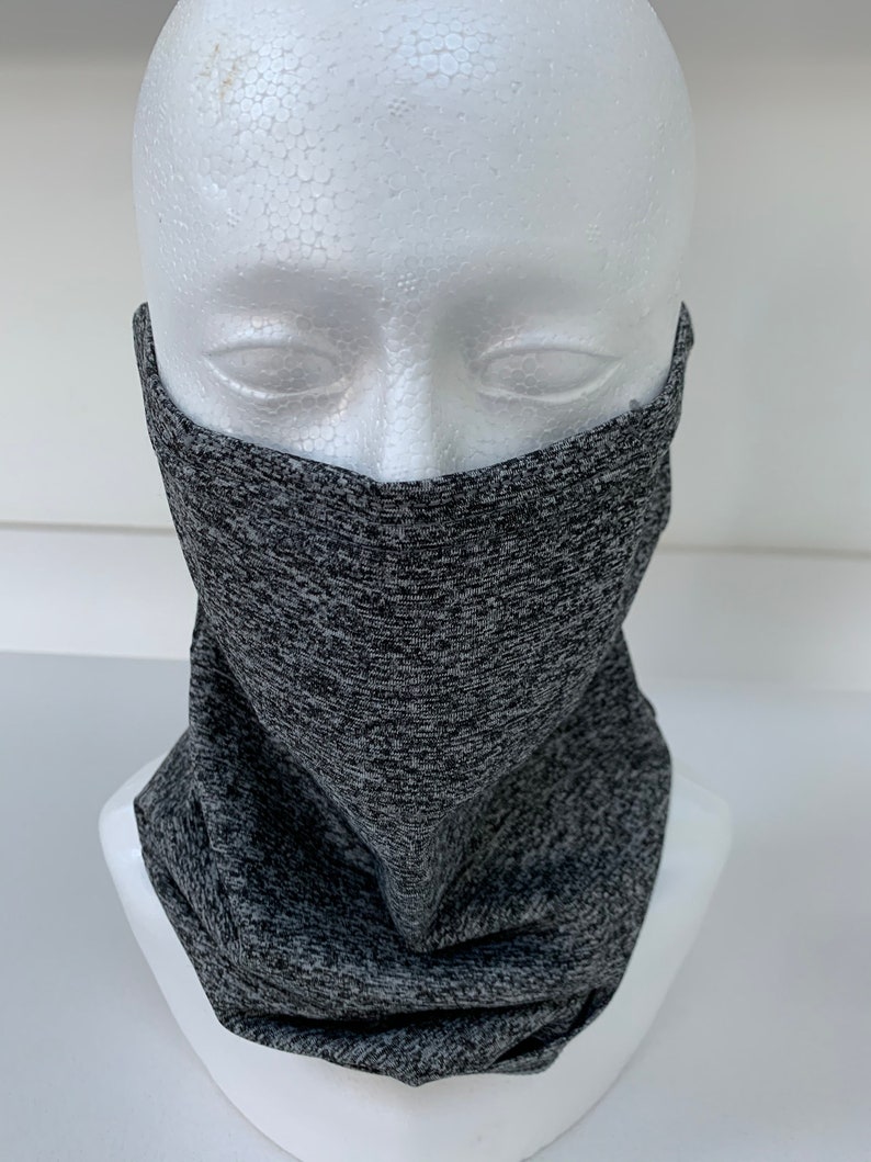 May include: Gray and black patterned neck gaiter, worn on a white mannequin head.