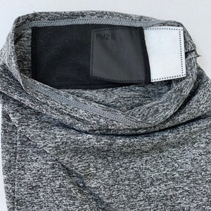 May include: Gray face mask with a black mesh panel and a white filter insert. The mesh panel has the text "PM2.5" printed on it.
