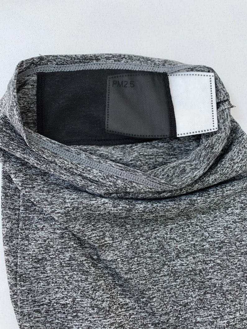 May include: Gray face mask with a black mesh panel and a white filter insert. The mesh panel has the text "PM2.5" printed on it.