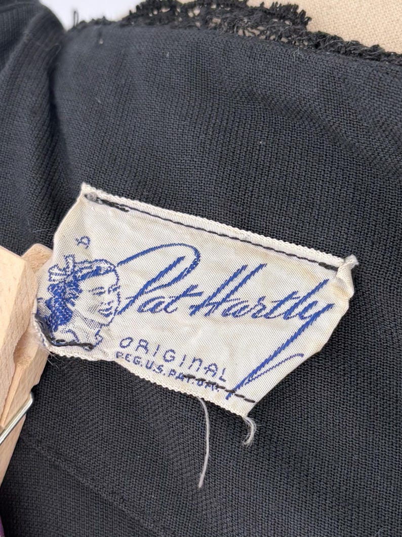 Close-up of the interior showing the label. The label features the name "Pat Hartley" in blue script, along with an illustration of a woman's face and the text "ORIGINAL REG. U.S. PAT. OFF."