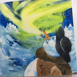 Pupazzo di neve che ammira l'aurora boreale