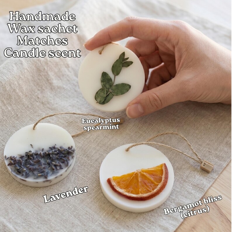 a hand holding a handmade wax sachet with various scents, including lavender, eucalyptus, and citrus.