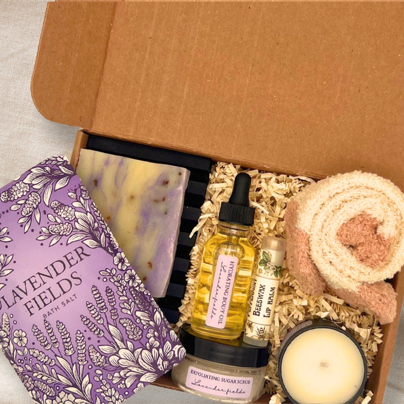 an open box containing a candle, soap, and other items