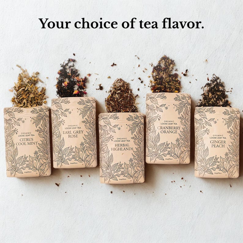 May include: Five packets of loose leaf tea, each with a different flavour: Citrus Cool Mint, Earl Grey Rose, Herbal Highlands, Cranberry Orange, and Ginger Peach. The text "Your choice of tea flavor" is at the top.