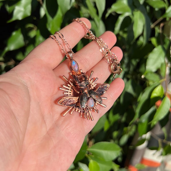 Small stag beetle holding a rainbow moonstone on a halo, with crazy sparkly texture, copper eformed necklace, unique piece Egyptian inspired