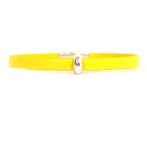 May include: A yellow leather bracelet with a silver bead clasp.