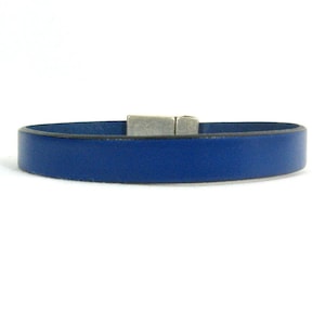 May include: A blue leather bracelet with a silver magnetic clasp.