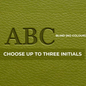 May include: Close-up of a textured, olive-green surface with the embossed letters "ABC". The text "BLIND (NO COLOUR)" and "CHOOSE UP TO THREE INITIALS" are also visible.