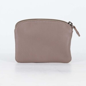 May include: A taupe-colored coin purse with a smooth, matte finish and a rounded top edge. The pouch features a matching taupe zipper closure along the top, complete with a small, thin leather pull tab attached to the silver-toned metal zipper slider.