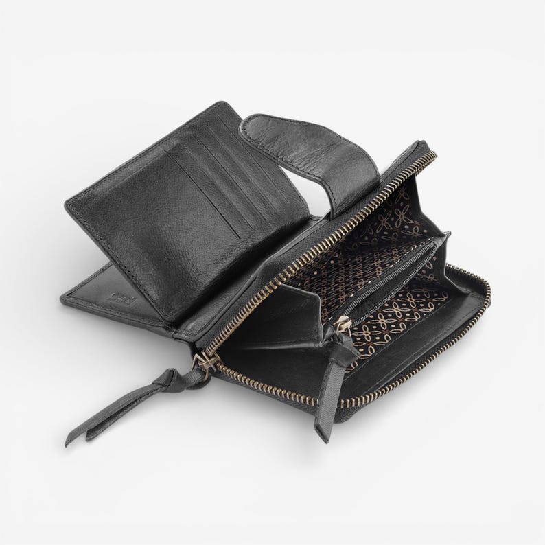 May include: Black leather wallet, open to display card slots and a zipped coin compartment. The interior lining features a patterned design. The wallet has a zip closure and a leather pull tab.