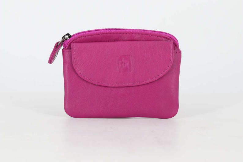 May include: A vibrant magenta leather coin purse featuring a top zipper closure and a front flap pocket with a snap button. The front flap displays a small embossed square logo. The compact accessory has rounded corners and a smooth, matte finish.