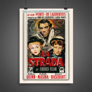 May include: A vintage movie poster for the film "La Strada" directed by Federico Fellini. The poster features a red and white title with the names Anthony Quinn, Giulietta Masina, and Richard Basehart in black text.