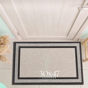 May include: A beige doormat with a black and gray border. The doormat has the text "30x47" printed on it.