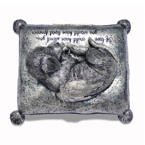 May include: Silver metal keepsake box with a sculpted image of a dog with wings sleeping on a pillow. The box has an inscription that reads "If love could have saved you, you would have lived forever."